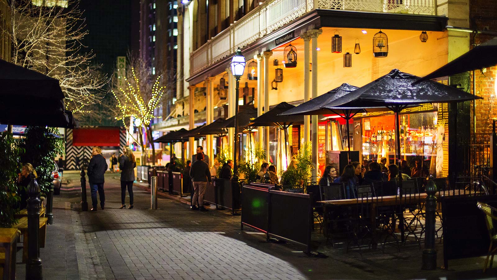 People in laneway restaurant at night