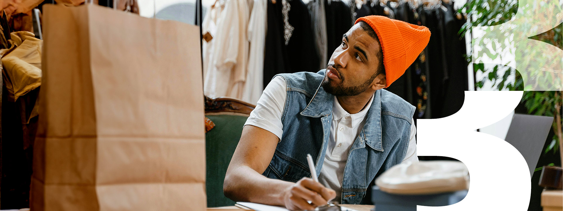 man in hat taking notes