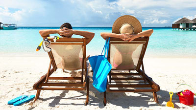 Man and woman relaxing on a beach.