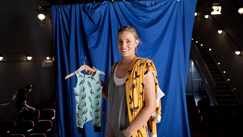 A woman showing several outfits, symbolising the small business resources Visa offers to employers