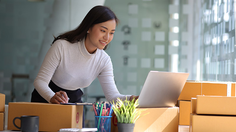 Starting a Small Business SME Owner Female Entrepreneur Reading and writing order numbers