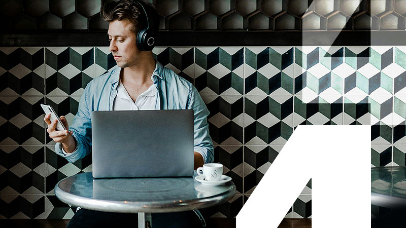 man with headphones sat at table